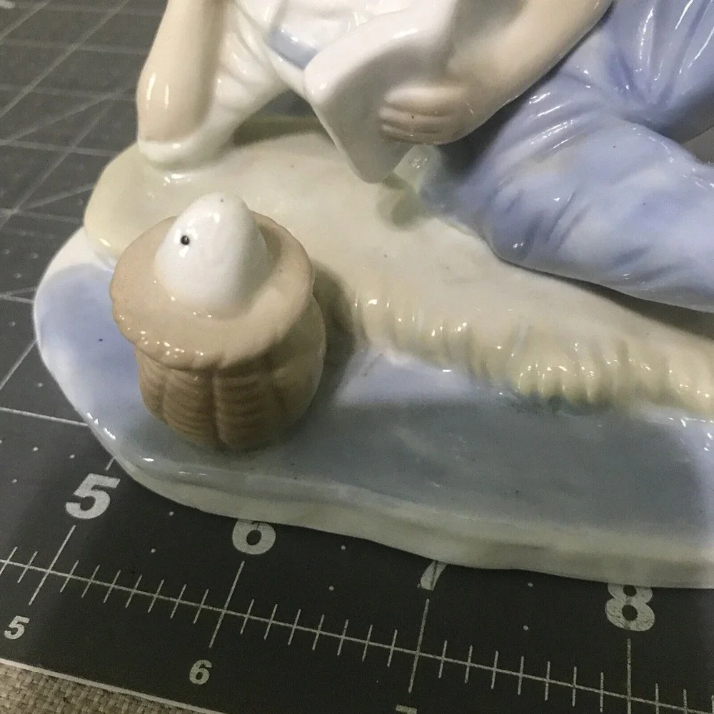 Vintage Porcelain Blue and White Boy Fish Figurine Propped Elbow‎ Reading